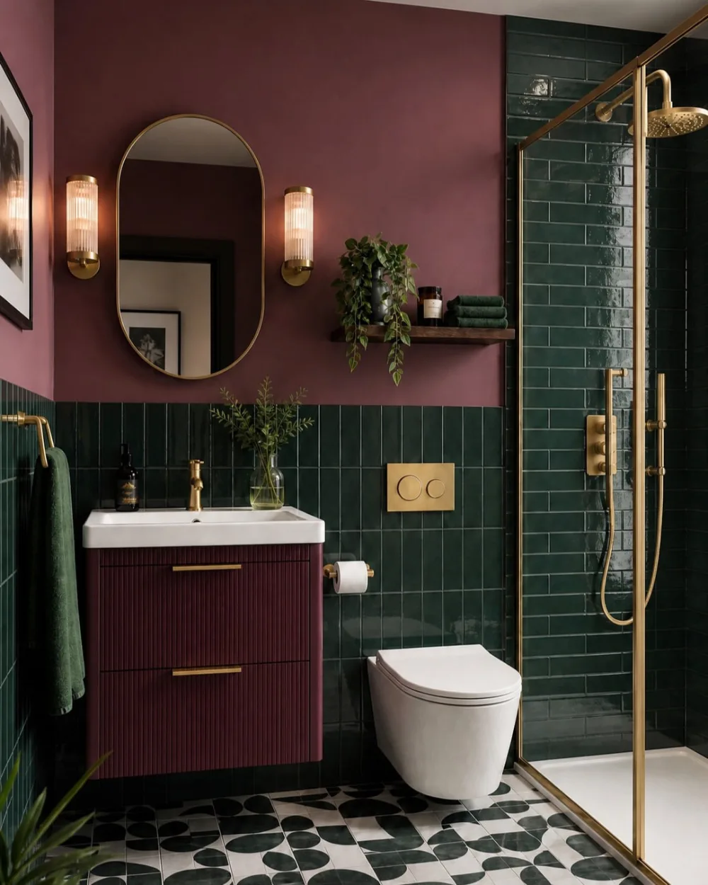 small bathroom with deep green tiles, burgundy vanity, gold fixtures, and patterned floor tiles