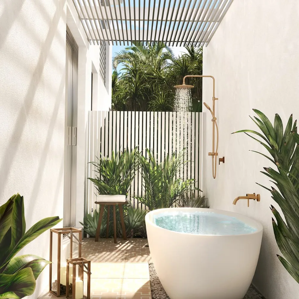 open-concept bathroom with a freestanding white bathtub, tropical plants, and slatted roof
