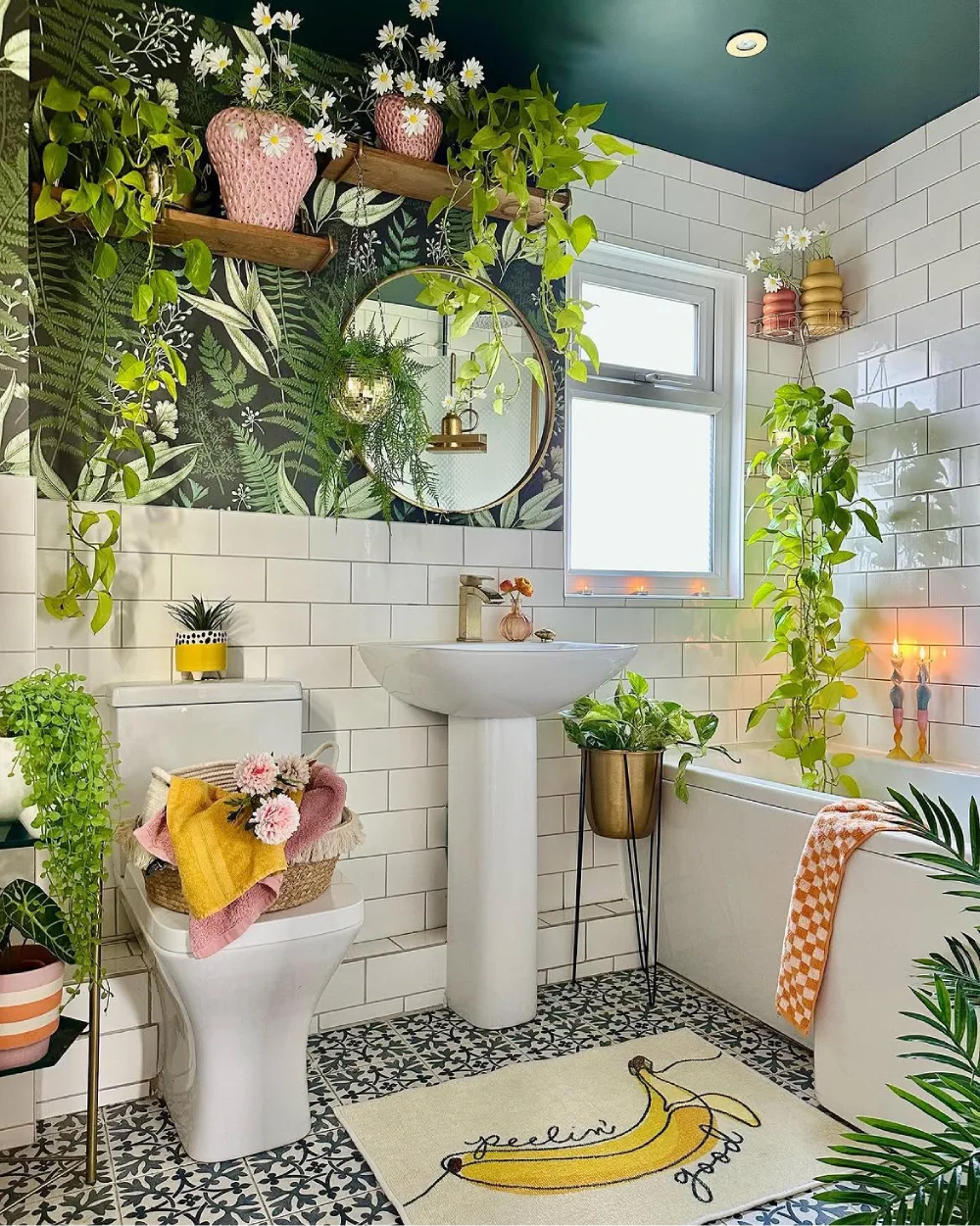 Colorful bathroom filled with trailing plants and floral decor