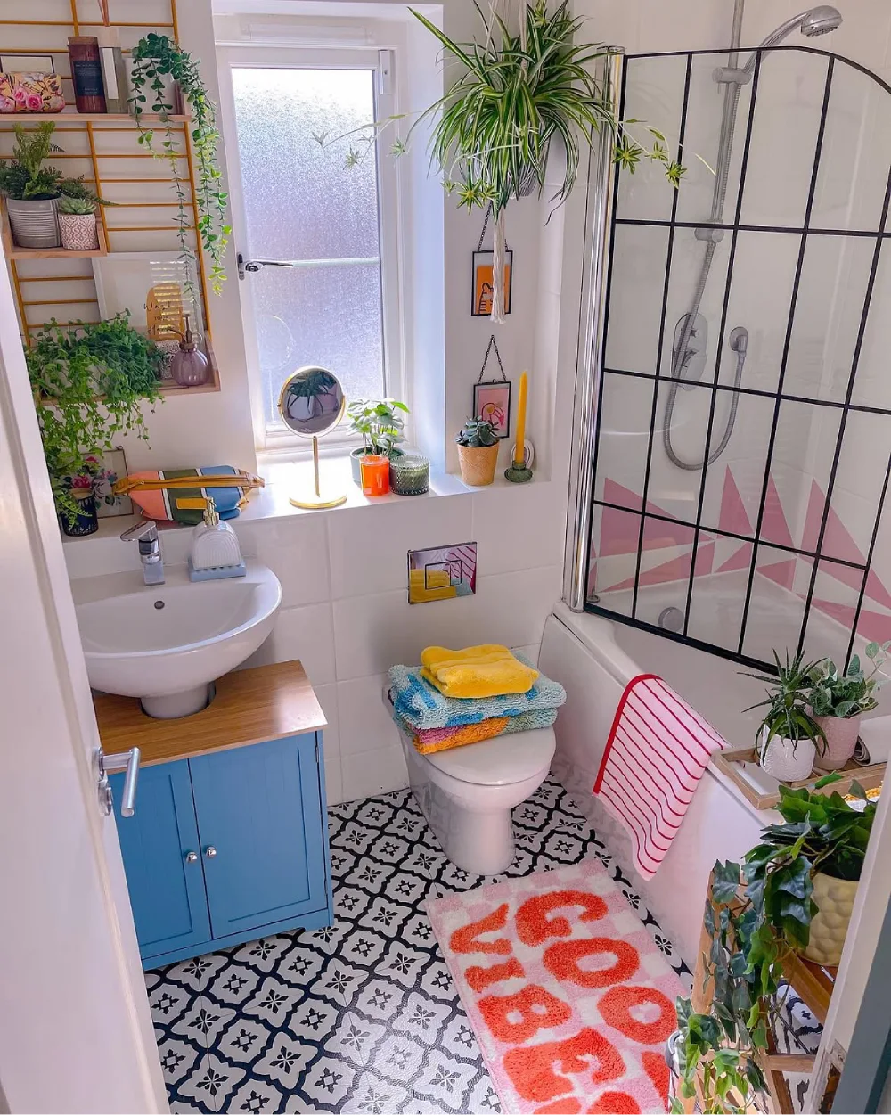 Small colorful bathroom with hanging and potted plants
