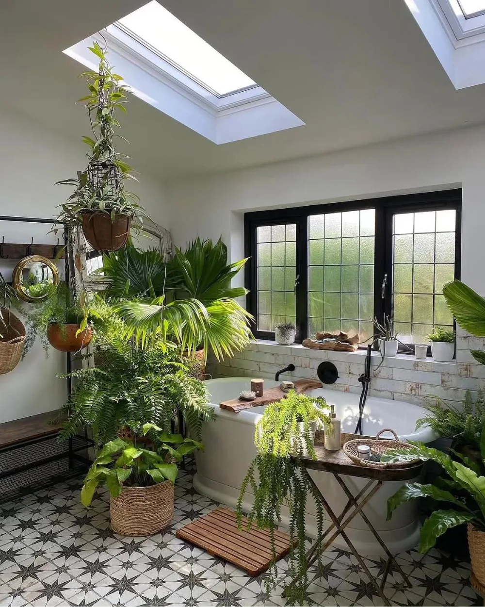 Freestanding bathtub surrounded by lush tropical bathroom plants