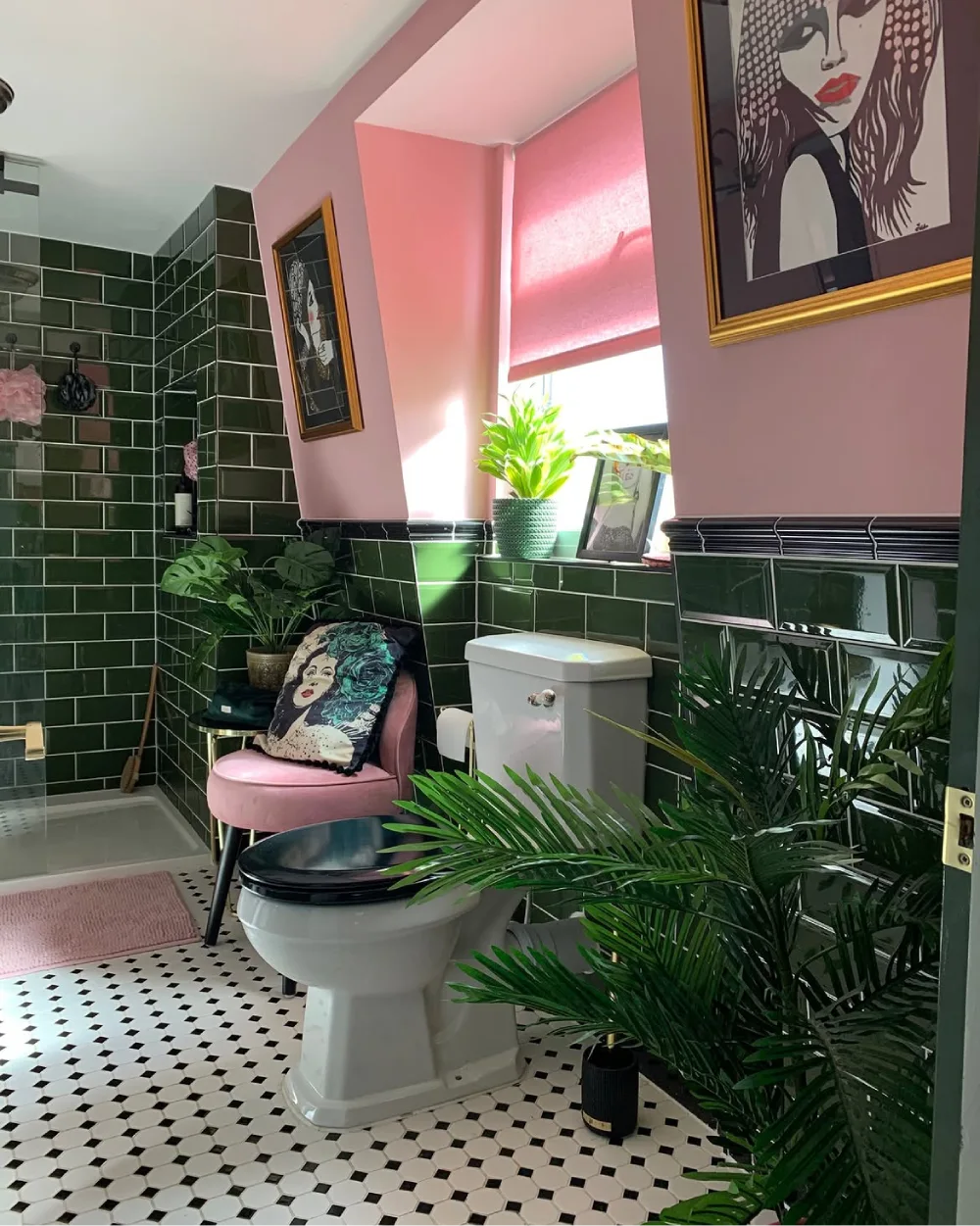 Pink and dark green bathroom decorated with tropical plants