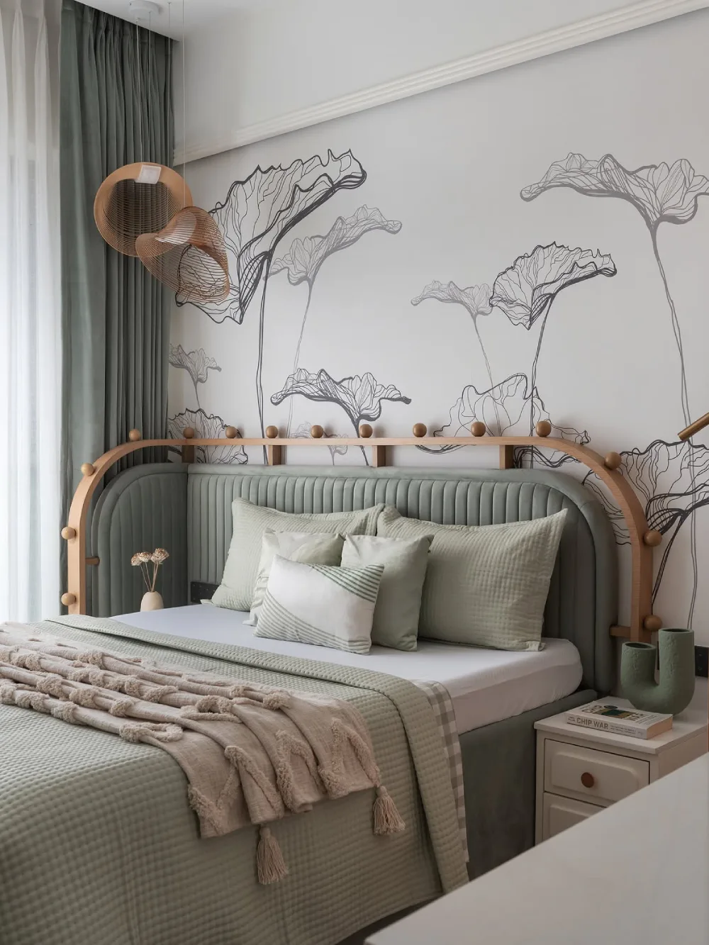 green bedroom with floral wall mural, curved upholstered headboard, and neutral bedding