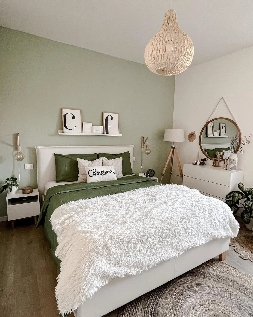 green bedroom with white bedding, fluffy throw, and simple natural decor