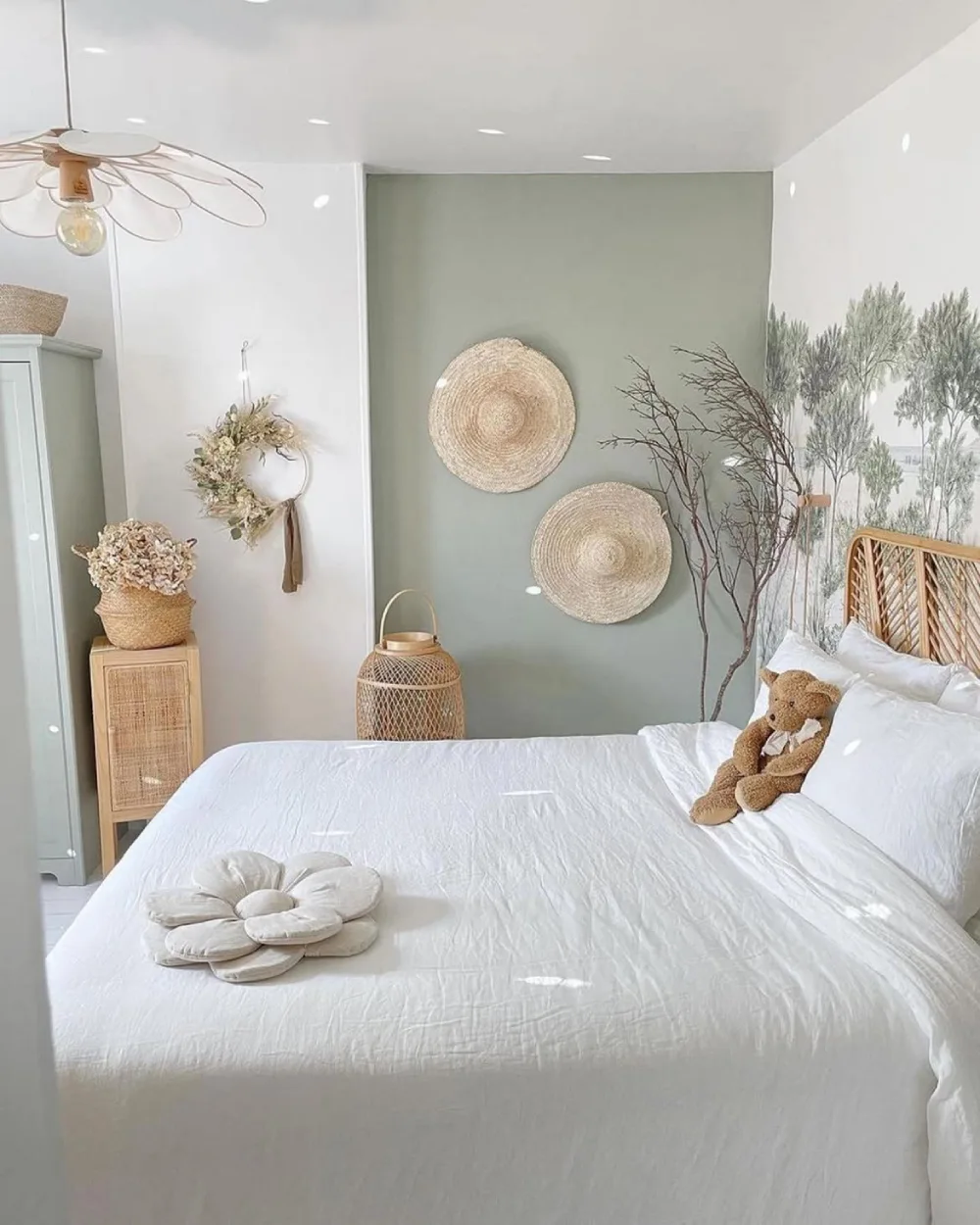 light green bedroom with woven wall decor, rattan furniture, and white bedding