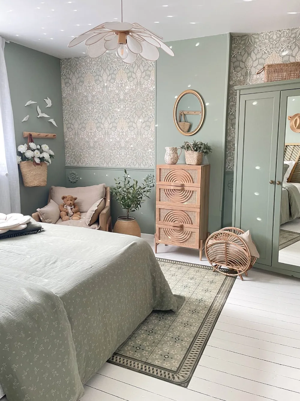 green bedroom with rattan furniture, floral wallpaper, and woven accents