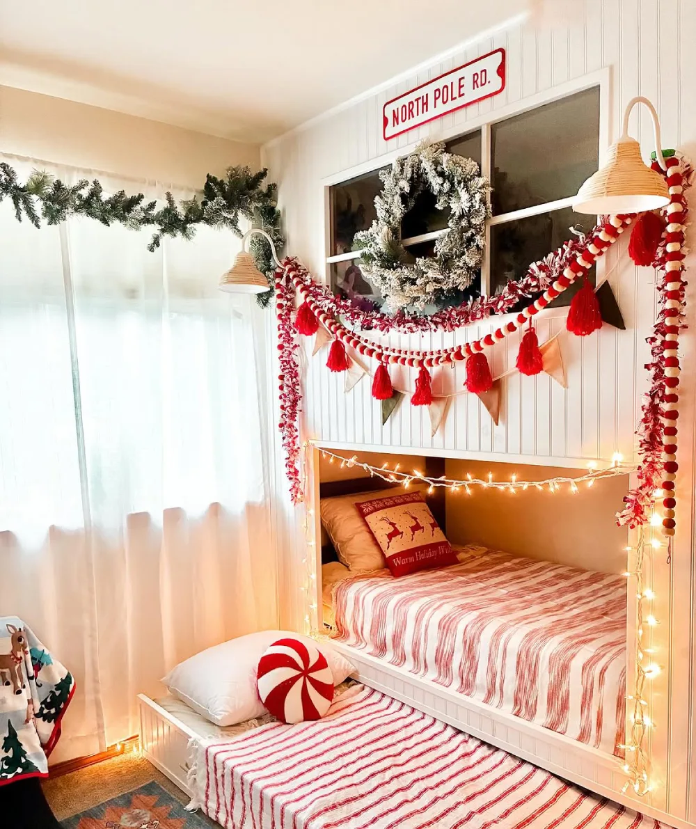 Children's bedroom with two beds, Christmas garlands, candy cane decorations, and warm lights