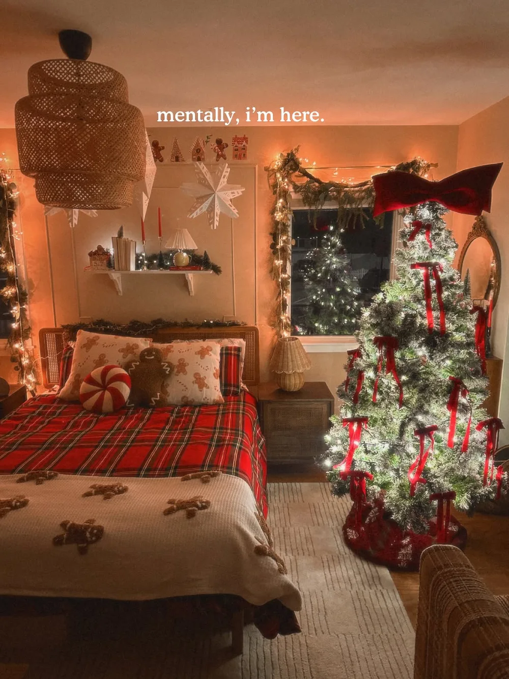 Warm Christmas bedroom with red plaid bedding, string lights, and a decorated tree