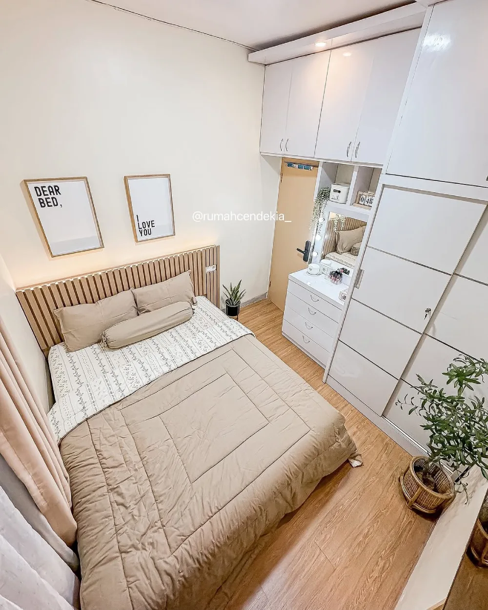 Small bedroom with a white wardrobe, compact desk, storage shelves, and a neatly made bed