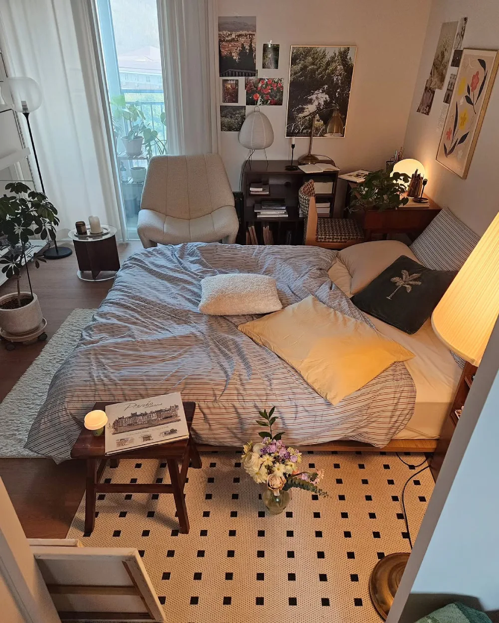 Small bedroom with a bed, desk, chair, bookshelves, and compact furniture