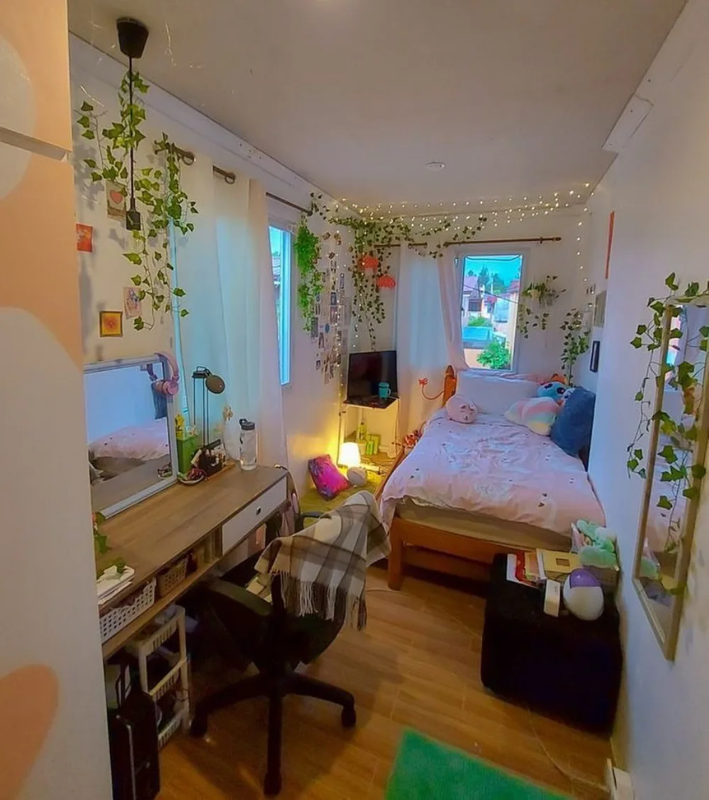 Small bedroom with a compact desk, chair, single bed, and wall decor