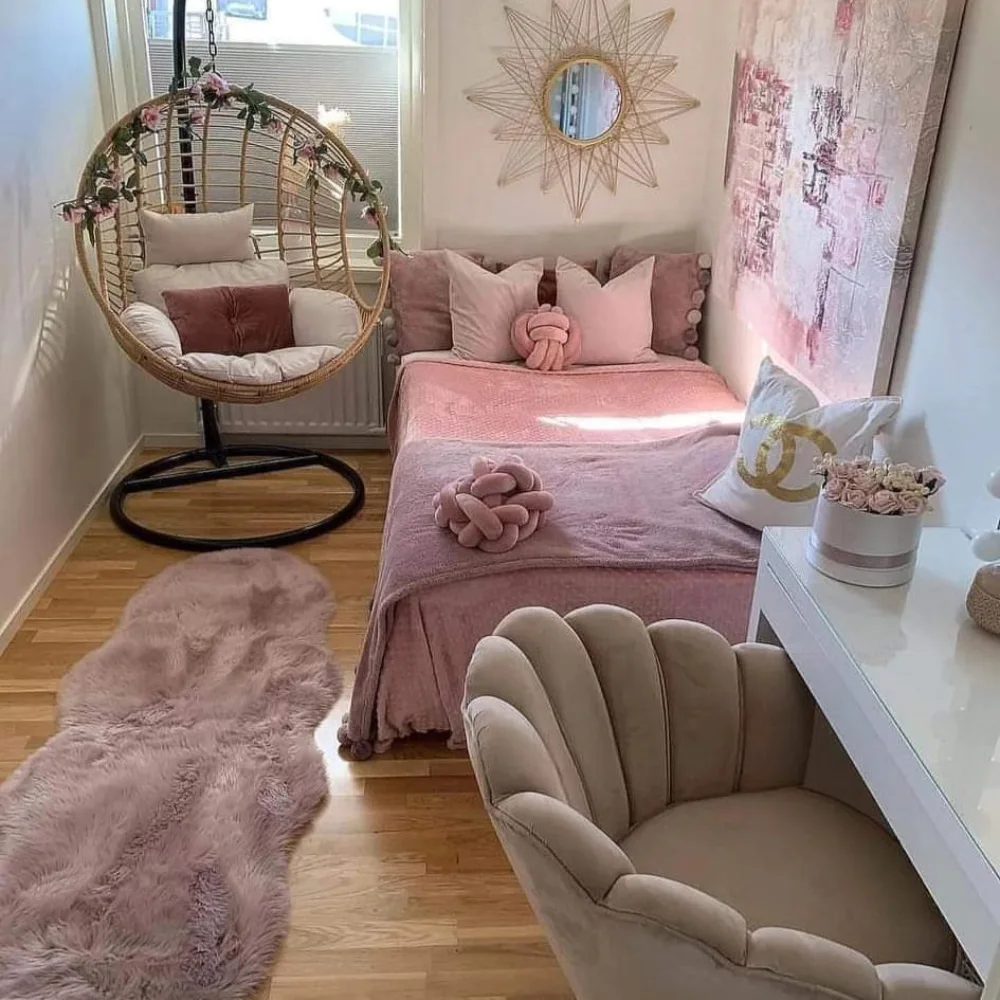 Small pink bedroom with a hanging egg chair, bed, vanity desk, and compact seating