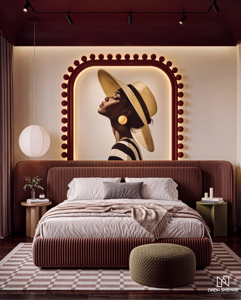 Burgundy upholstered bed with a statement portrait above it, cream bedding, warm lighting, and a geometric patterned rug