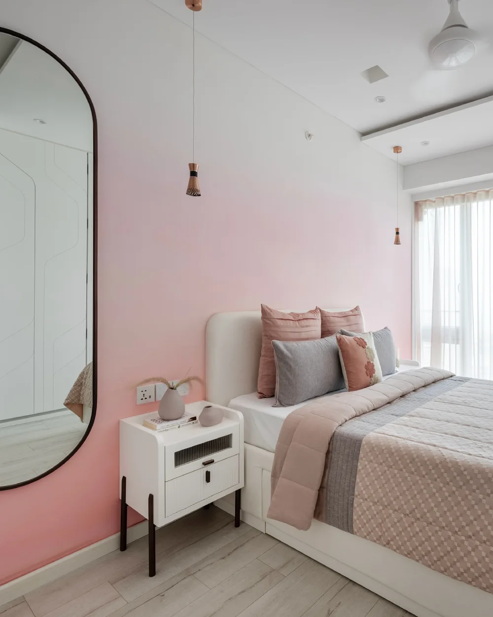 Soft pink and gray bedroom with white furniture and neutral bedding