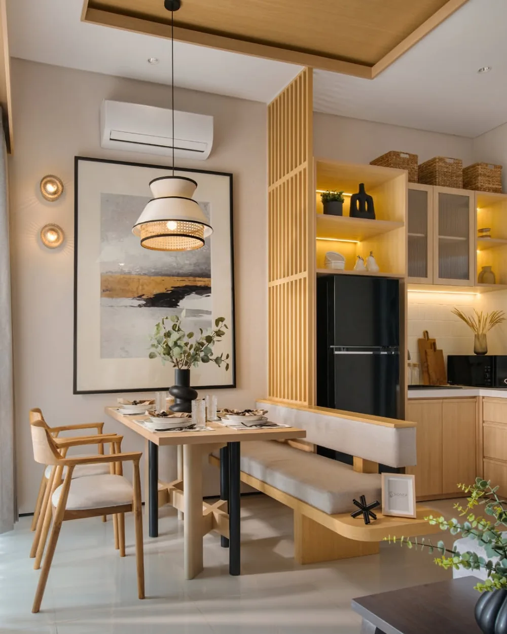 Open dining area directly beside a warm wood kitchen with a built-in bench and slatted wood divider
