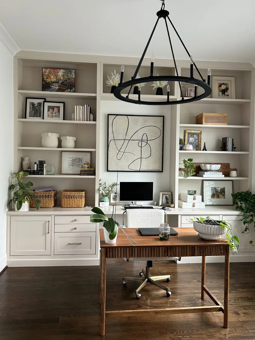 classic built-in home office bookshelf with books, plants, and decorative accents