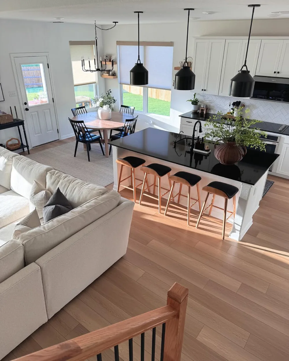 open-concept kitchen with black island connected to a living room