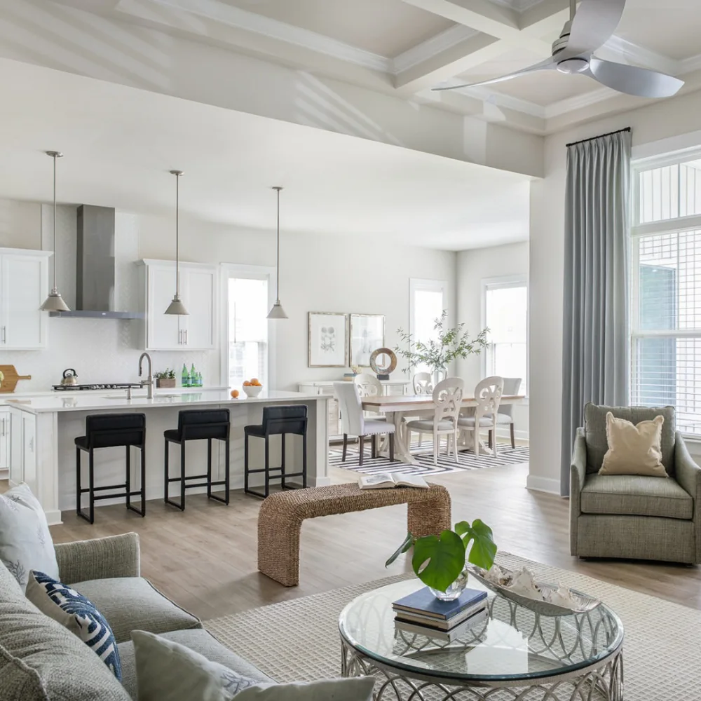 open-concept kitchen with white island, dining area, and living room