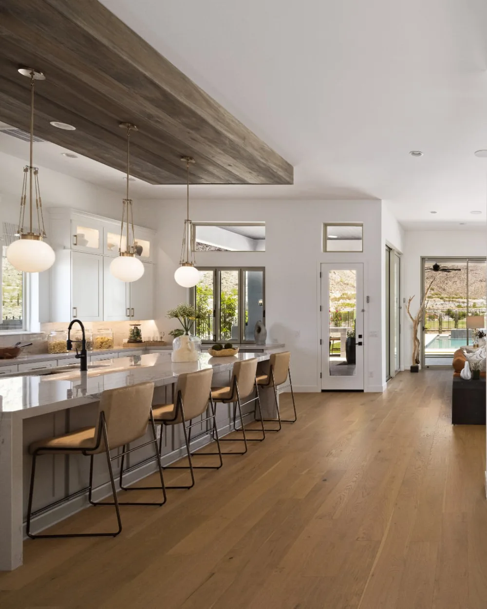 open-concept kitchen with a wood ceiling, white cabinets, and long island