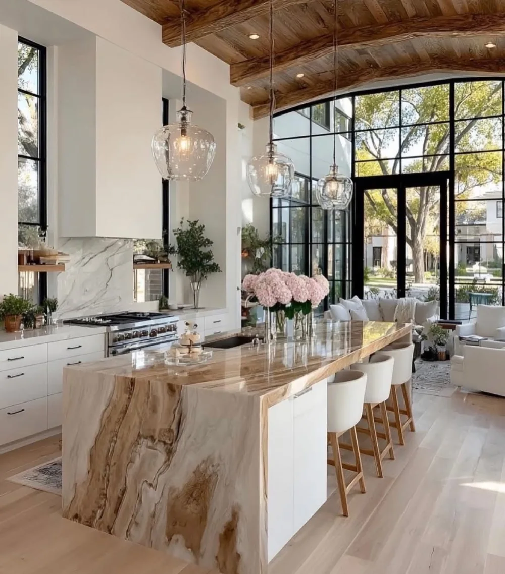 open-concept kitchen with a wood-look tile island and warm wood ceiling