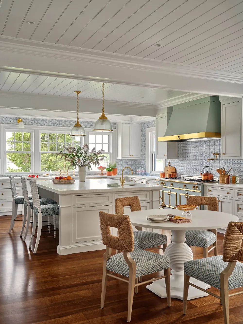 classic white open-concept kitchen with patterned backsplash and dining area