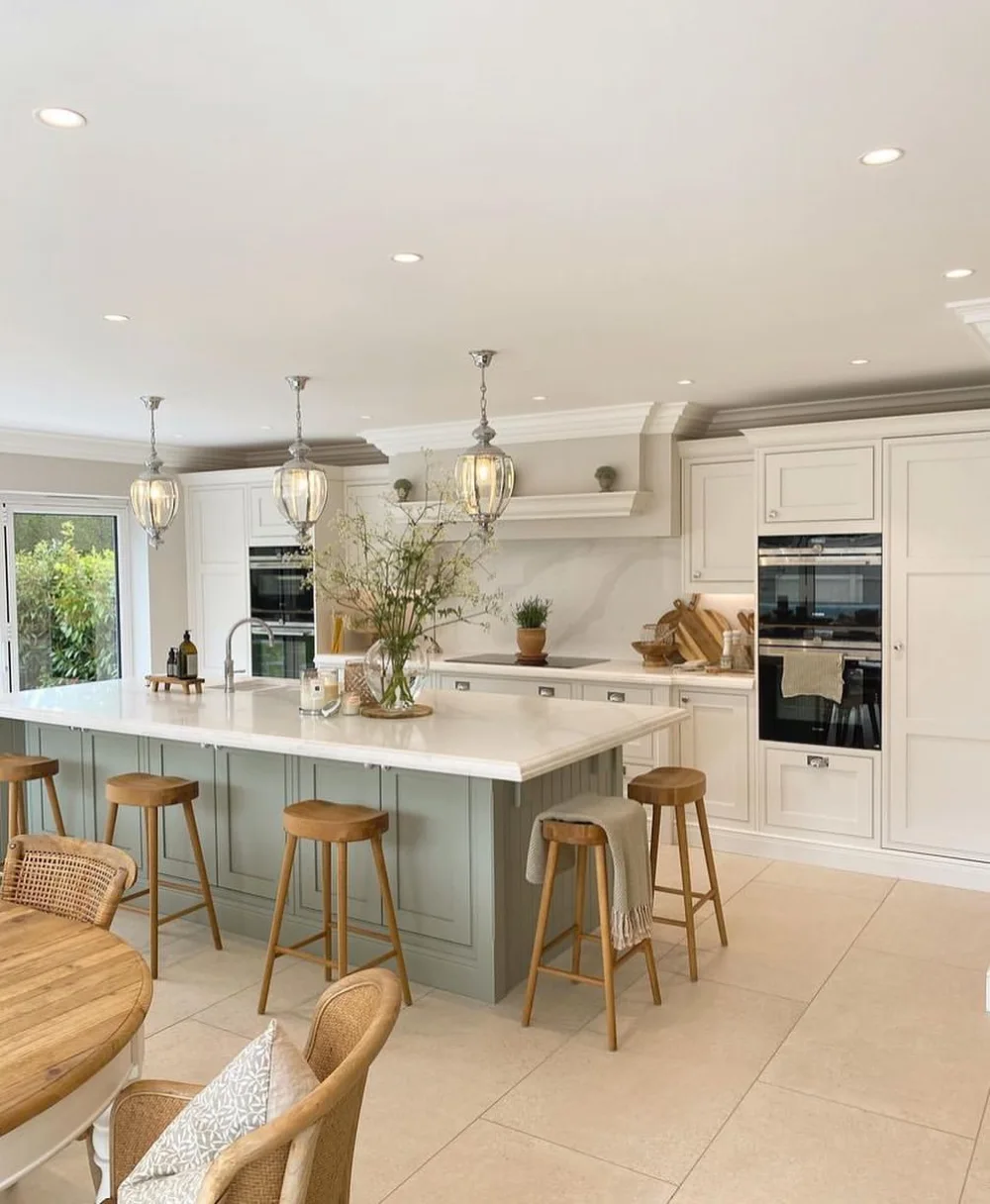 classic open-concept kitchen with white cabinets and large central island