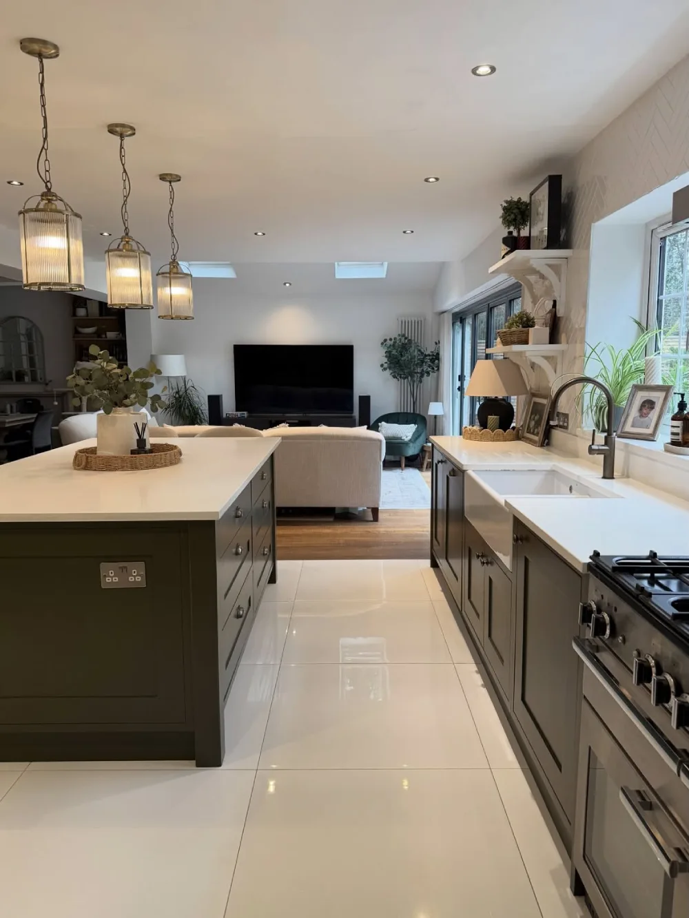 open-concept kitchen with dark cabinetry, long island, and connected living room
