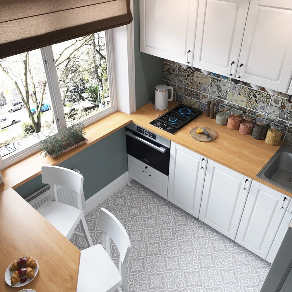 Small white kitchen with wood countertops, patterned floor tiles, and a large window