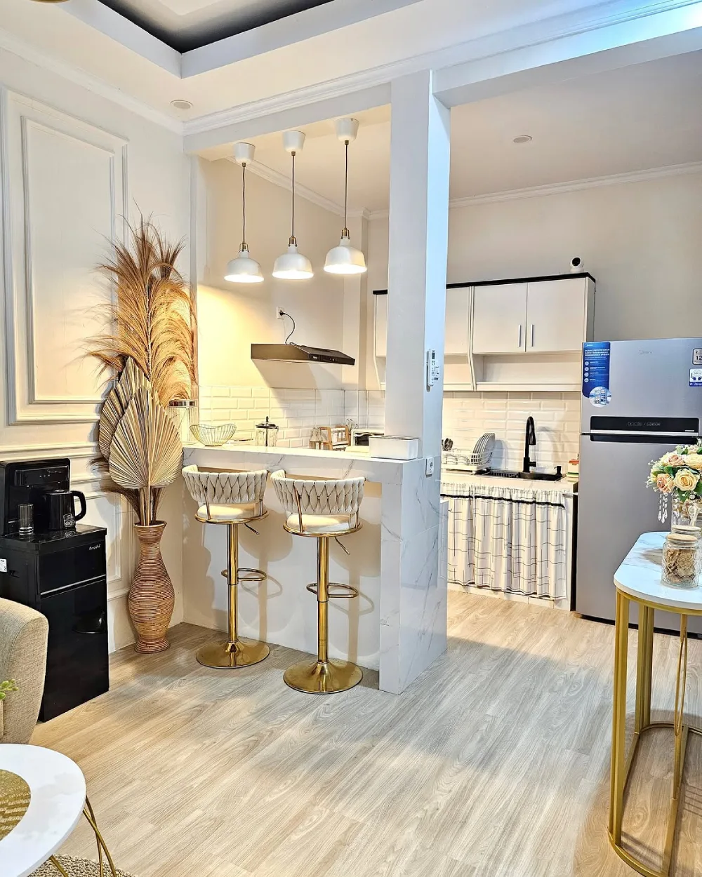 Compact kitchen with a breakfast bar, pendant lights, and white cabinetry