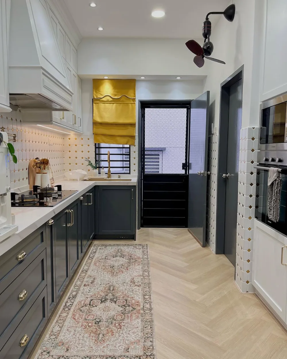 Narrow light green kitchen with tall cabinets and a glass door