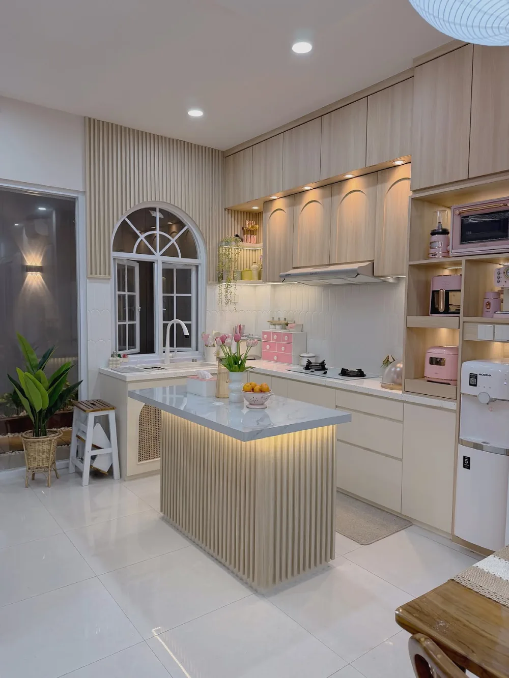 Compact cream kitchen with a central island and tall storage cabinets