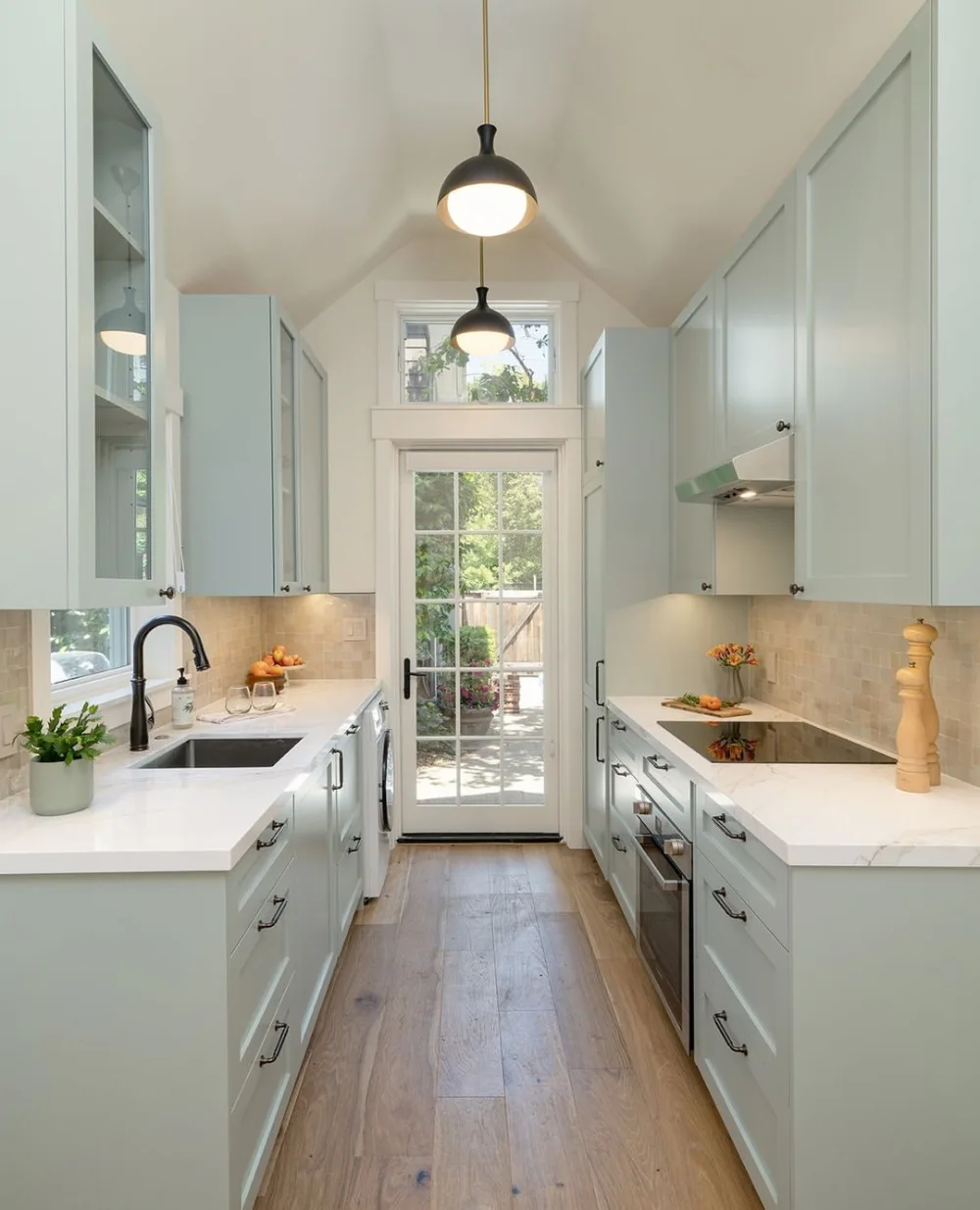 Small attic kitchen with pale cabinets, wood counters, and skylights