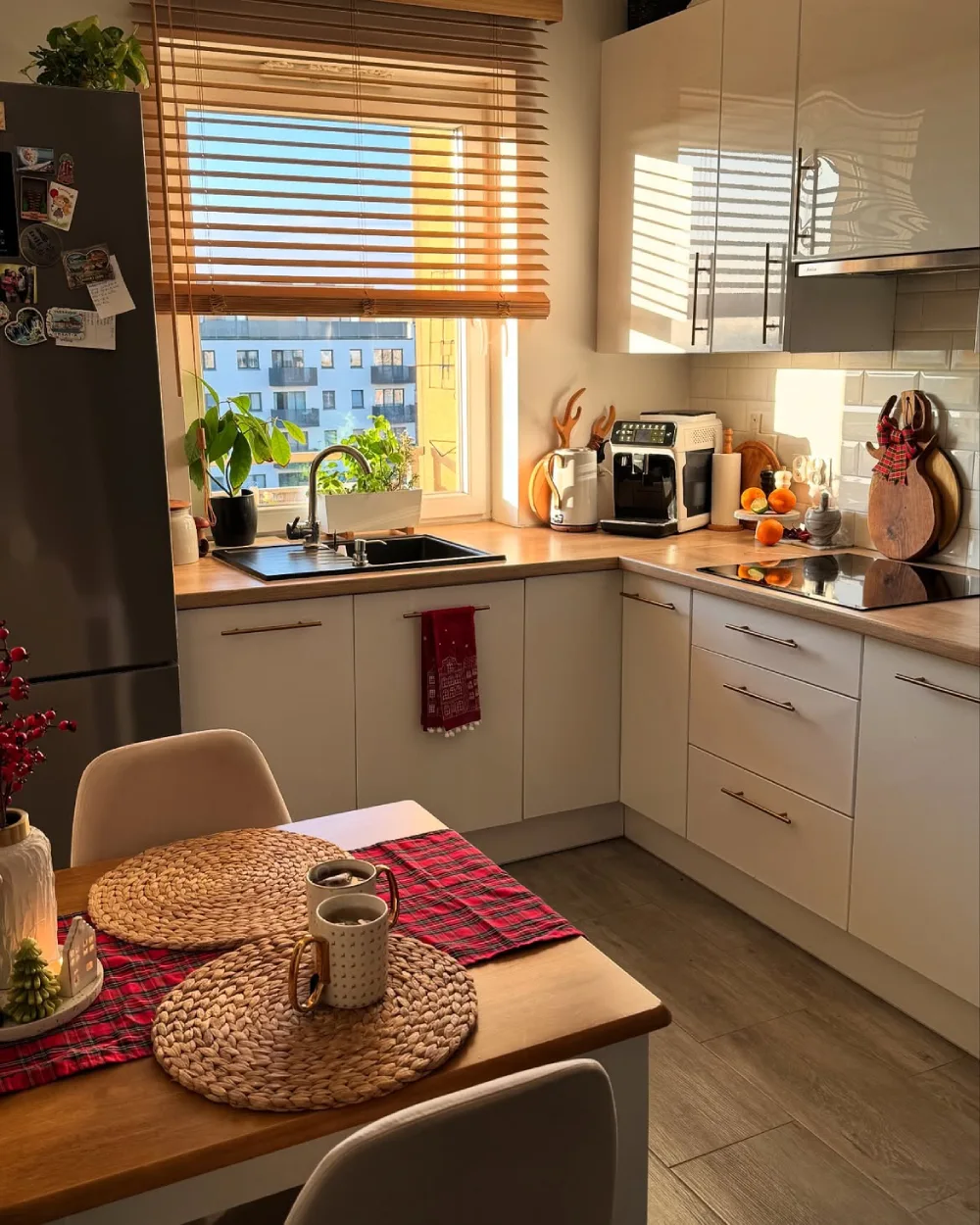 white kitchen with wood countertops, wooden blinds, and dining table with plaid runner