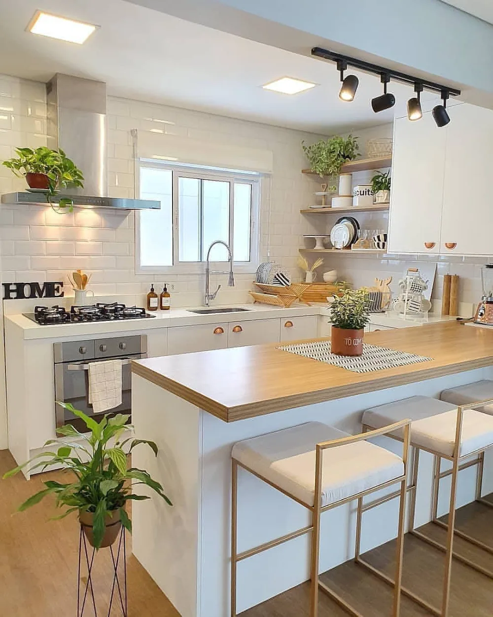 Bright small kitchen with white subway tile, open shelves, and natural wood accents