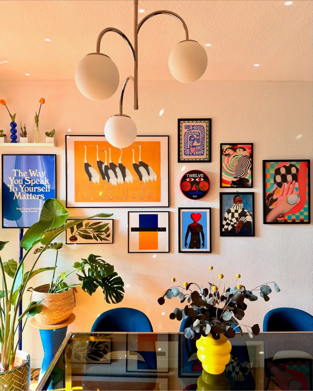 Colorful gallery wall with framed artwork above a light blue sofa