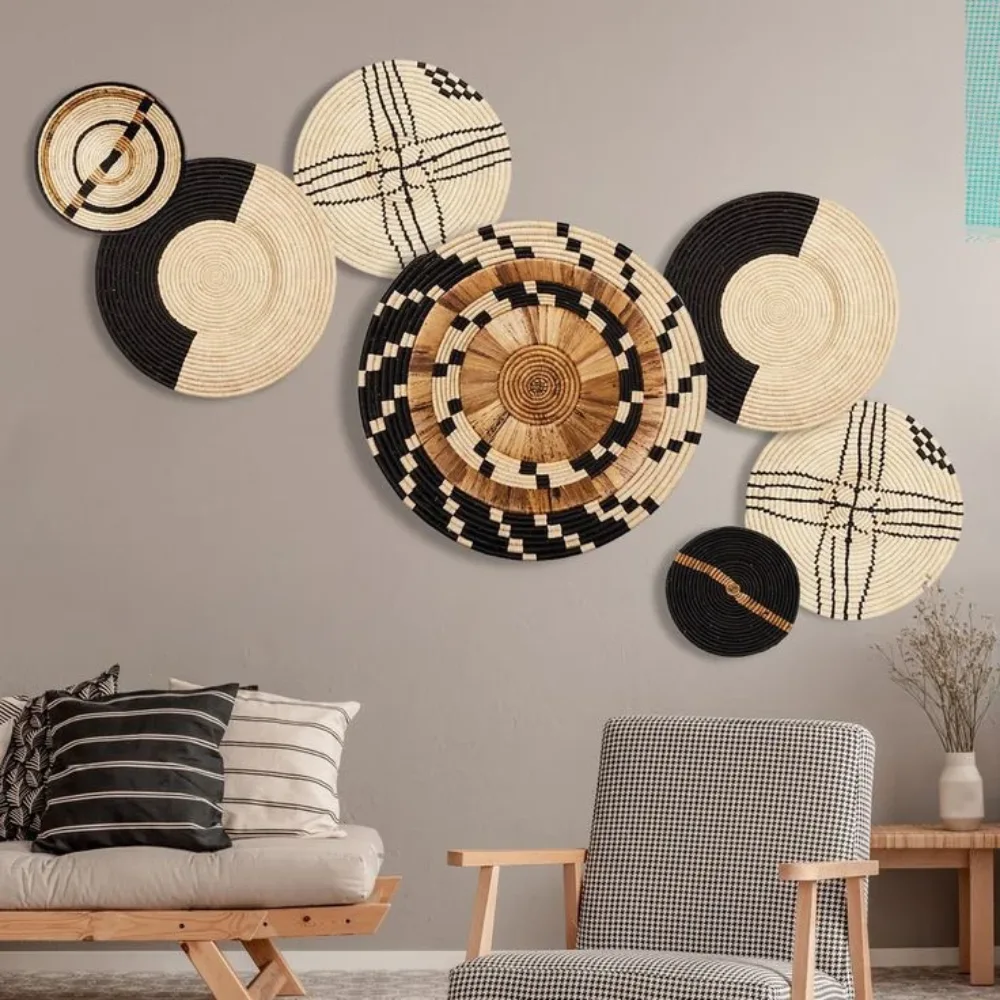 Decorative woven plates and baskets arranged on a living room wall