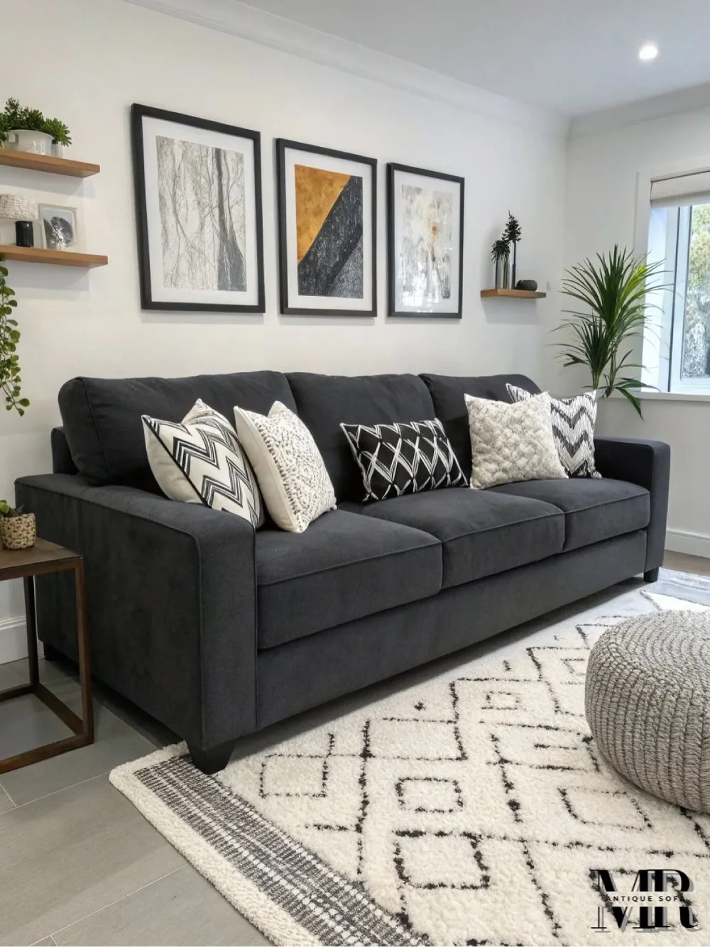 Dark gray sofa with black and white patterned pillows and geometric rug