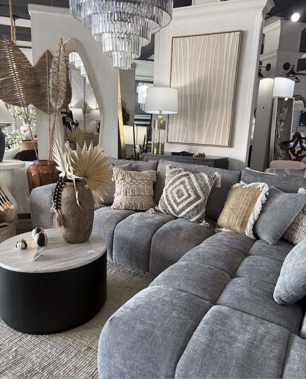 Gray sectional sofa with textured pillows, woven decor, and neutral accents