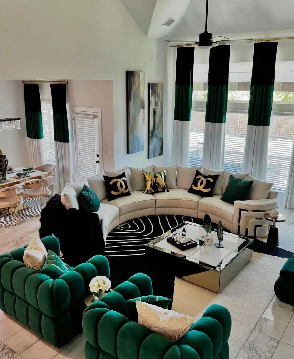 Emerald green accent chairs with a cream sectional and black and white decor