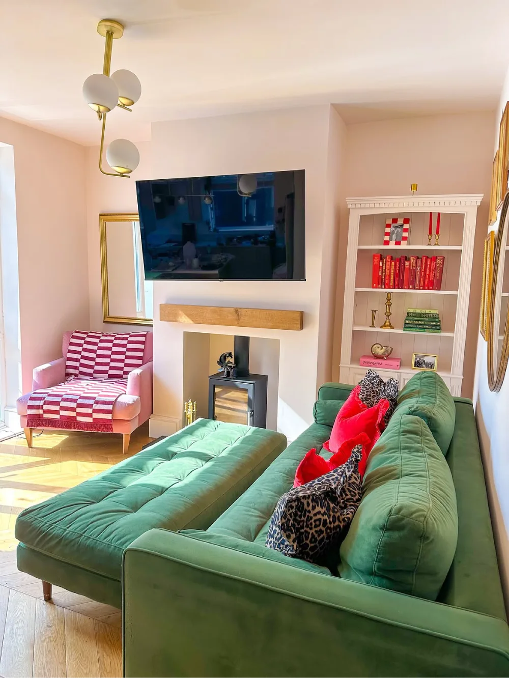 Light green sofa with colorful pillows and a matching ottoman in a bright living room