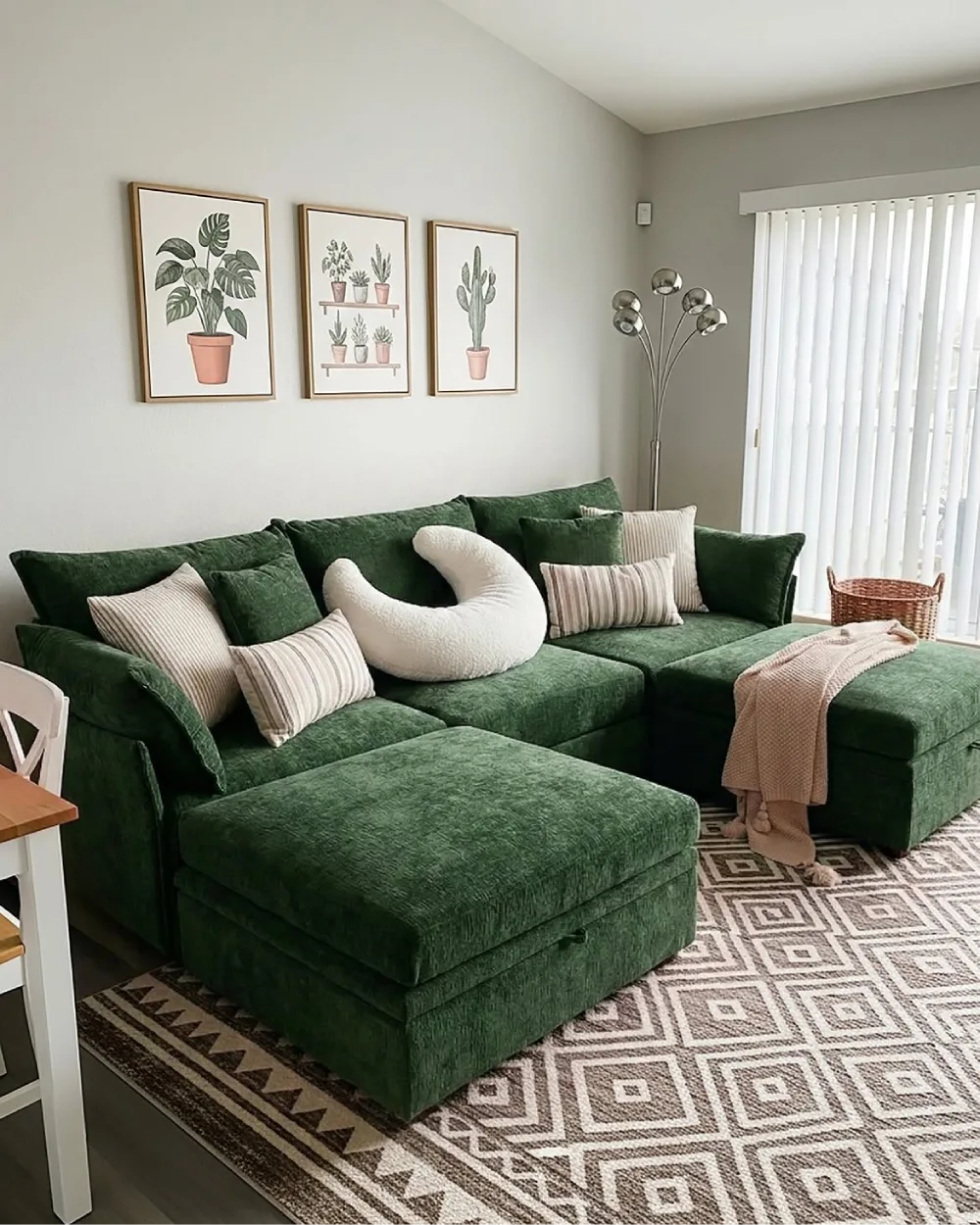 Deep green sectional with neutral pillows and textured rug in a cozy living room