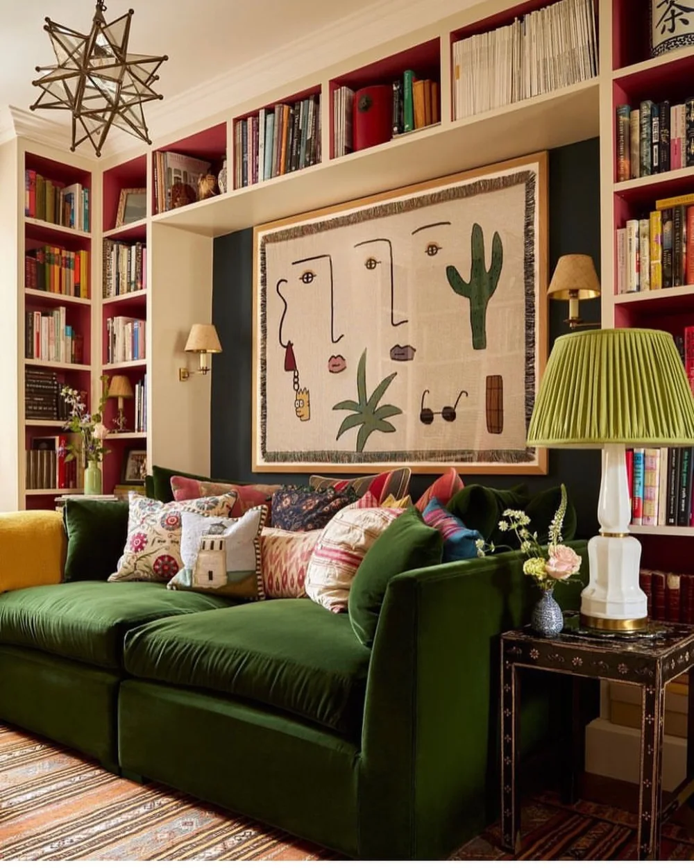 Dark green sofa with colorful patterned pillows and built-in bookshelves