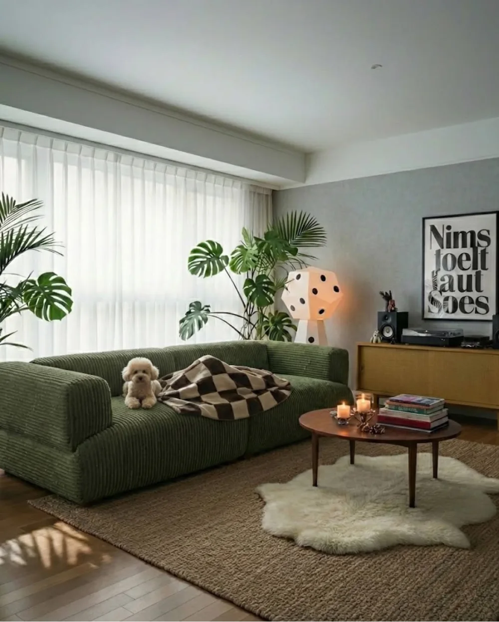 Olive green corduroy sofa with neutral pillows and natural textures