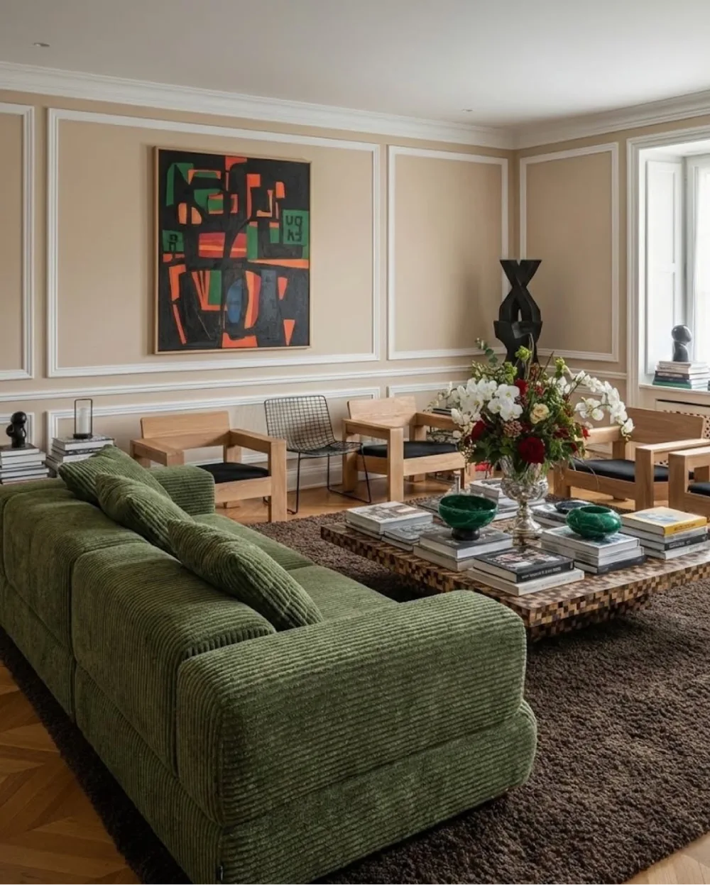 Olive green sectional in an elegant neutral living room with wood furniture