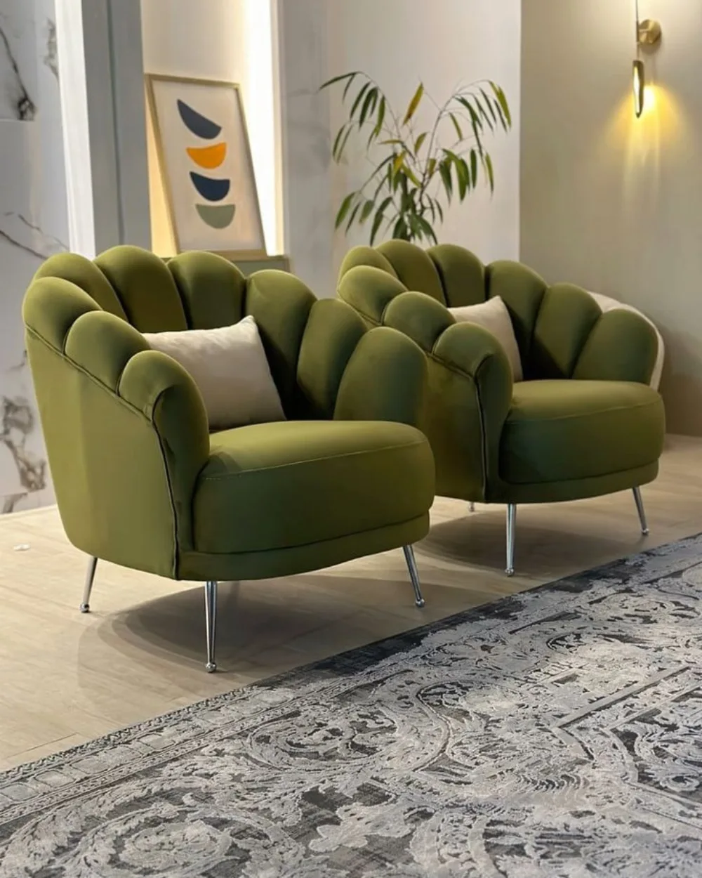 Olive green scalloped armchairs with white pillows in a modern living room