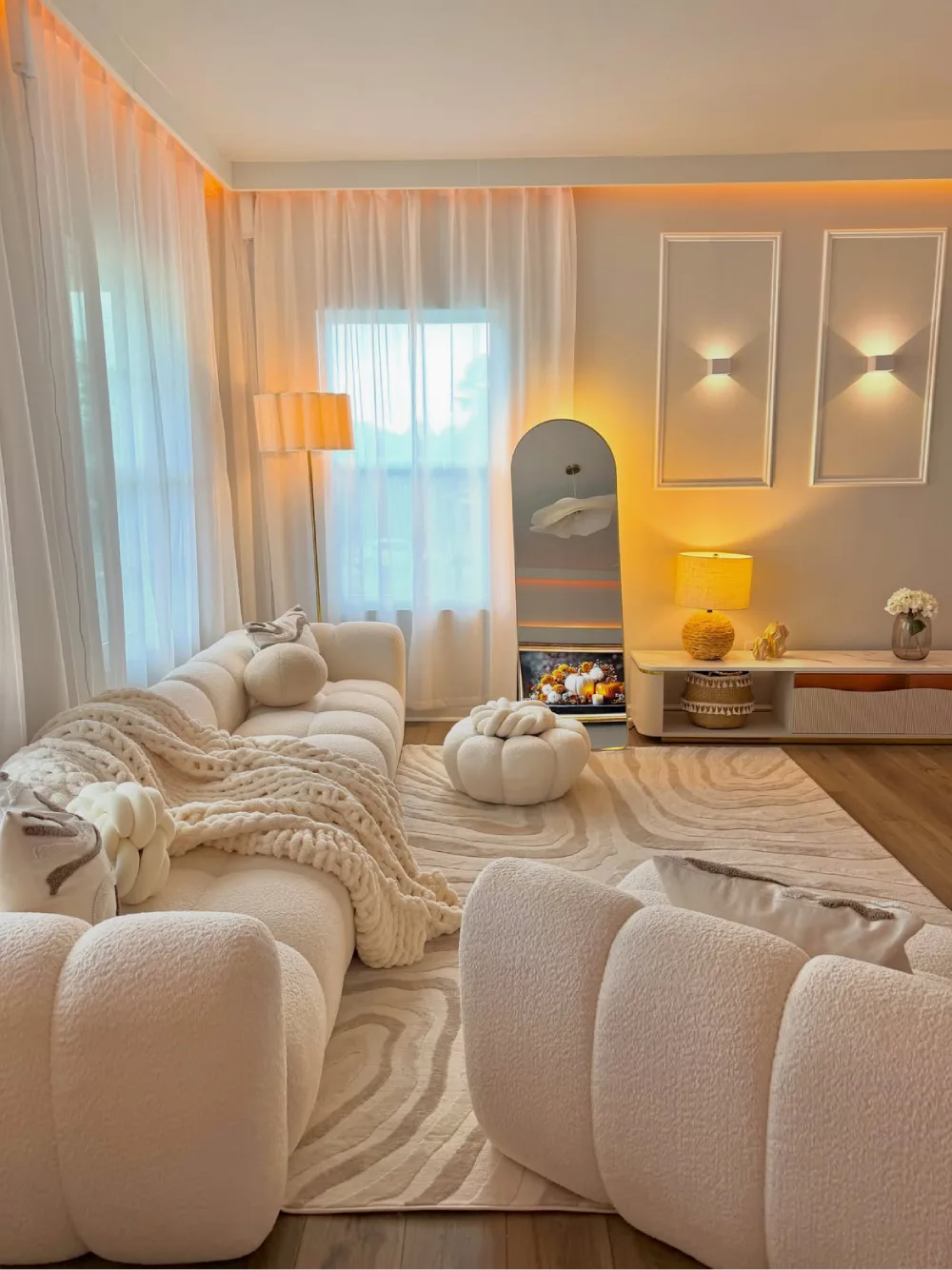 cozy cream living room with plush seating, soft lighting, and layered textures
