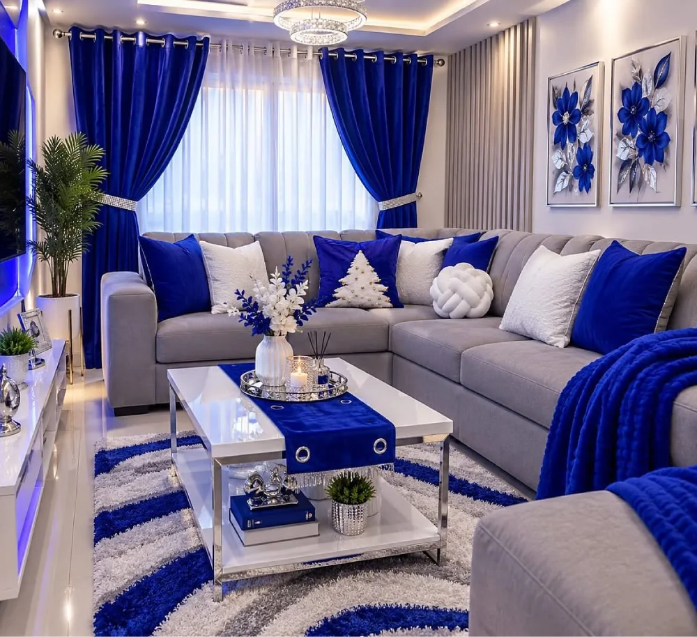 gray living room with bold royal blue curtains, pillows, rug, and sectional sofa