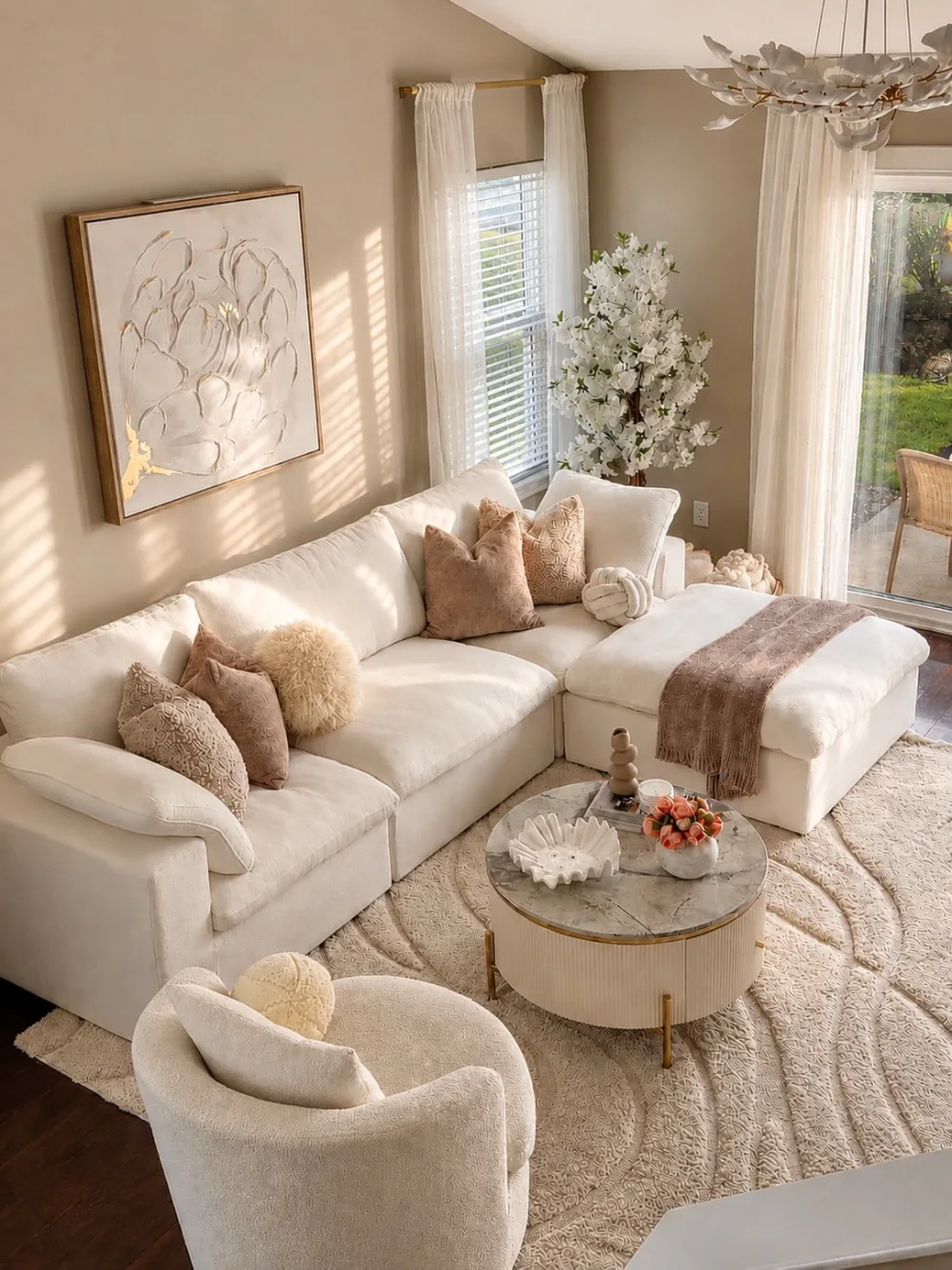 soft neutral living room with white sectional sofa, textured rug, and natural decor