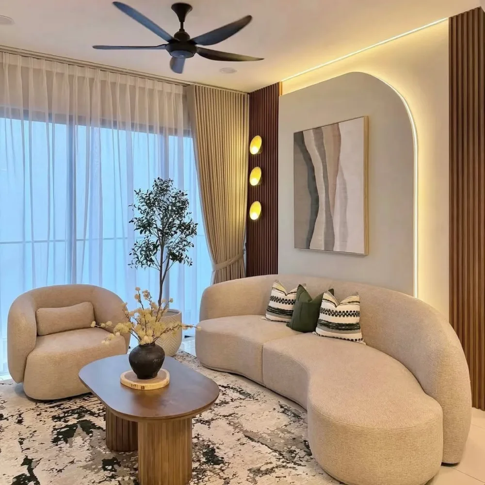 warm modern living room with curved beige sofa, wood paneling, and arched accent wall