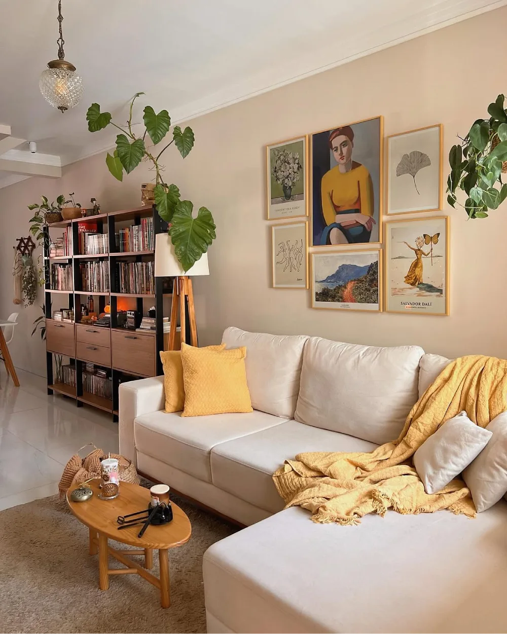 eclectic living room with yellow accents, gallery wall, plants, and cozy sectional sofa